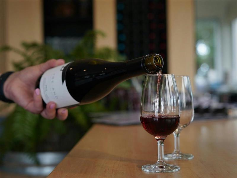 Pouring a glass of wine from a bottle