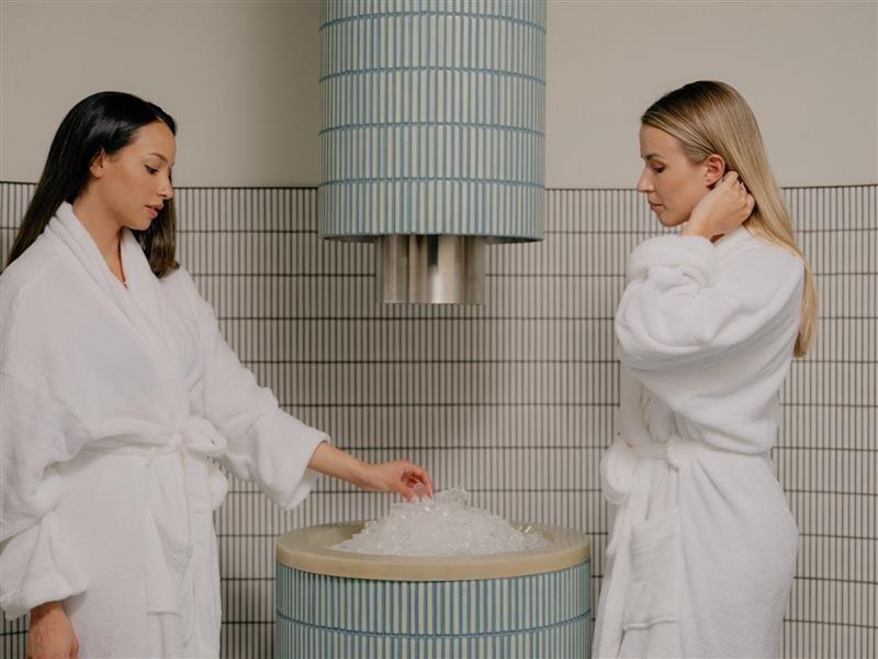 Two ladies standing at the ice fountain
