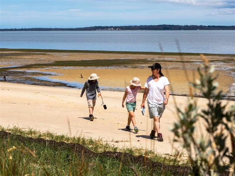 Family walking along French Island Beach