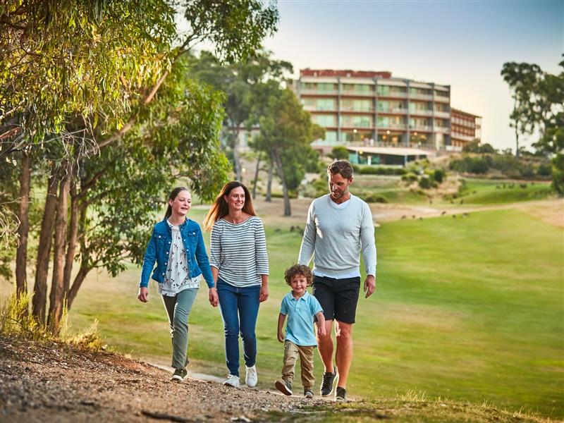 Happy family walking along track