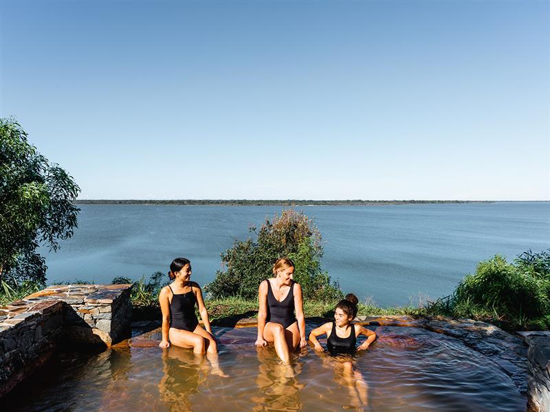 Three women soak in a hot tub at Metung Hot Springs at Metung, Gippsland.